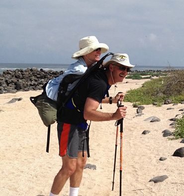 Dave carrying me in a backpack, on sandy beach in Galapagos Islands